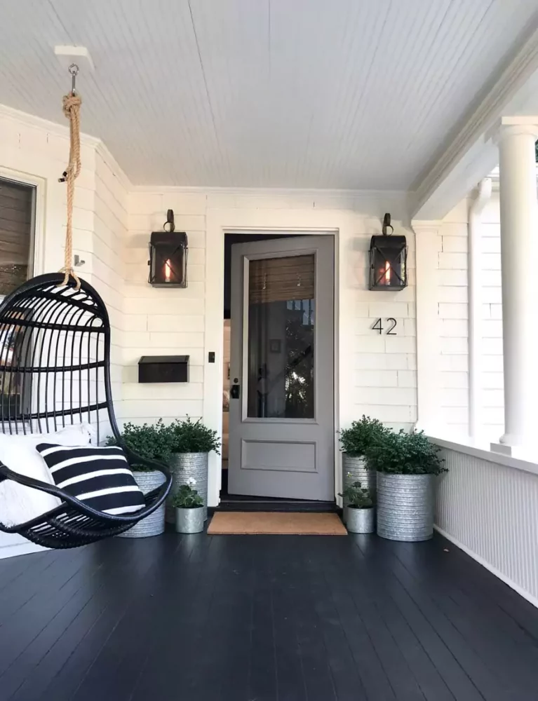 most lovely things white-cottage-traditional-style-porch-black-painted-floor-swing-hanging-chair-boxwoods