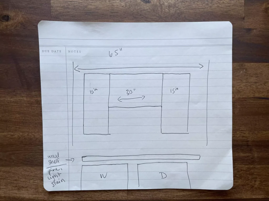 Hand-drawn laundry room design sketch on lined notebook paper, featuring layout ideas for appliances, shelves, and storage units. Rough pencil lines and handwritten notes suggest early planning stages for a home renovation project.